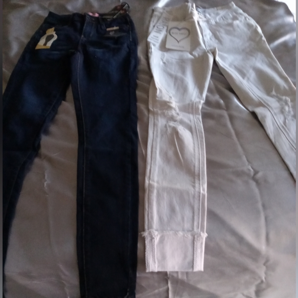 Skinny jeans, blue and white denim. White is distressed with folded pant leg. $